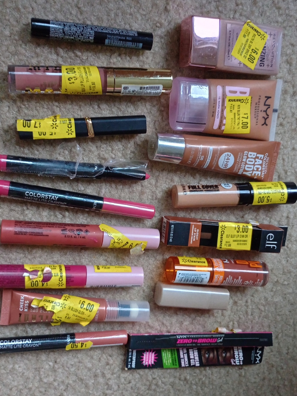 Collection of NYX Butter Gloss, Wet n Wild lip stains, and Revlon ColorStay Matt